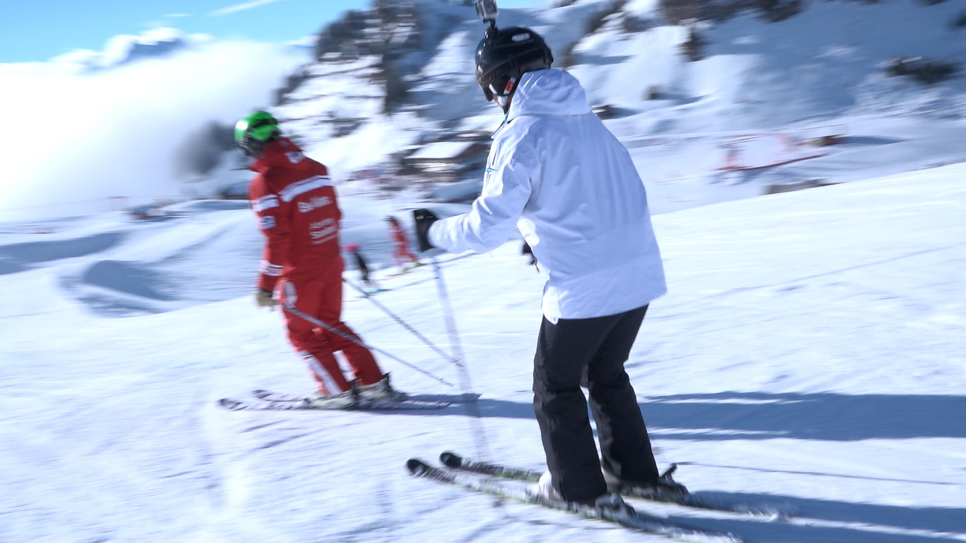 Woman skiing behind instructor
